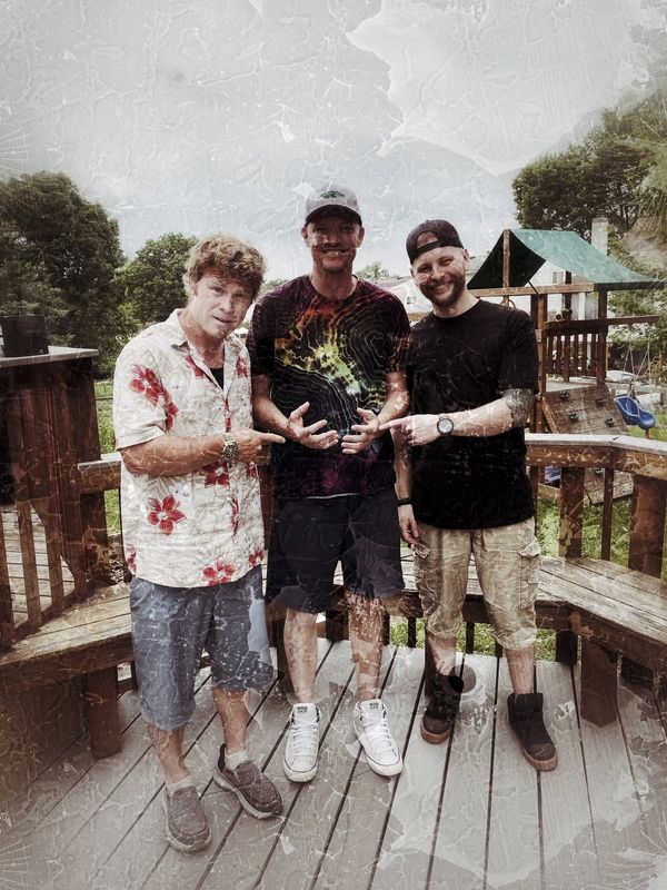 The band on a wooden deck outdoors